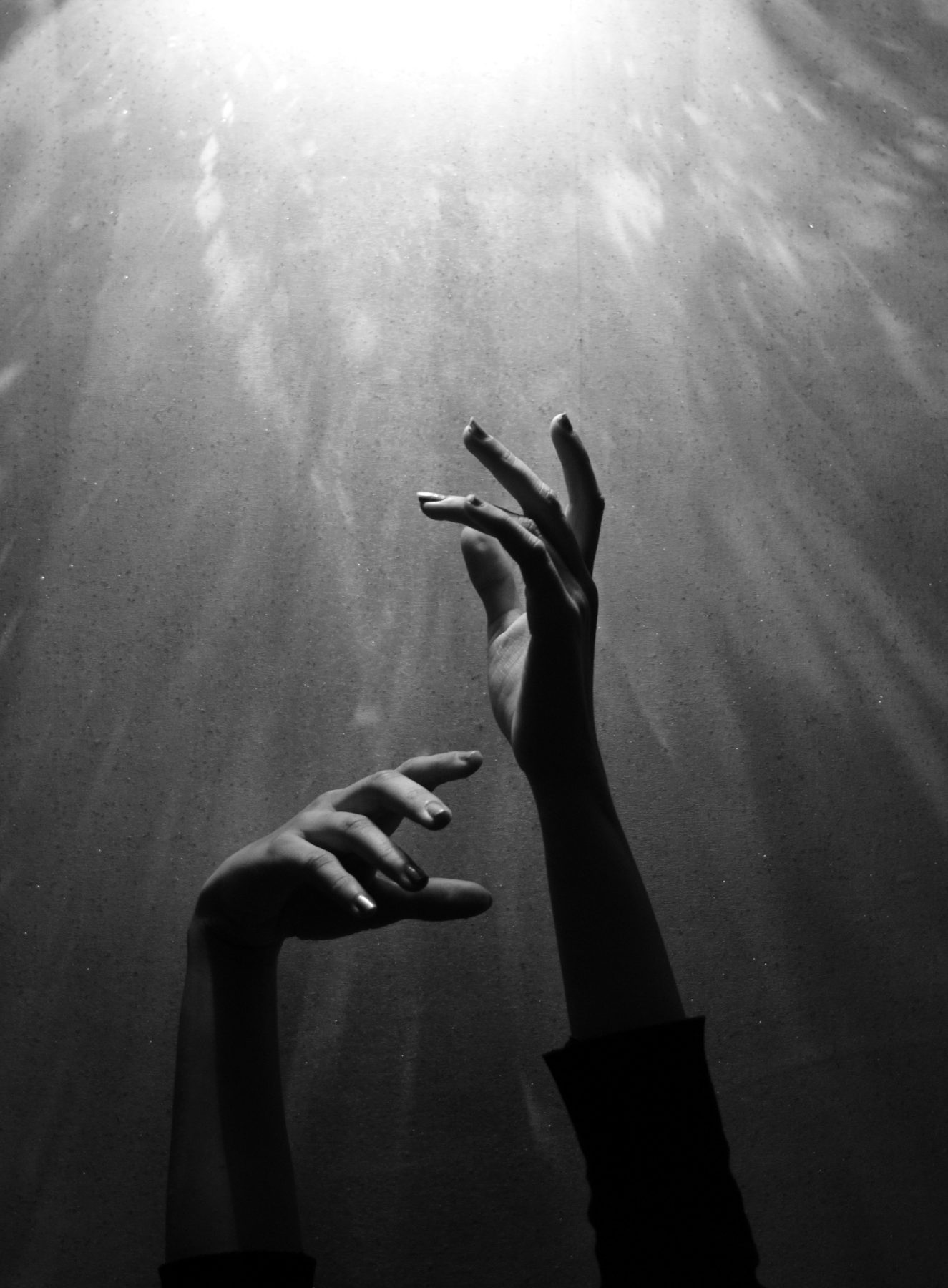 An open hand emerging from shadow